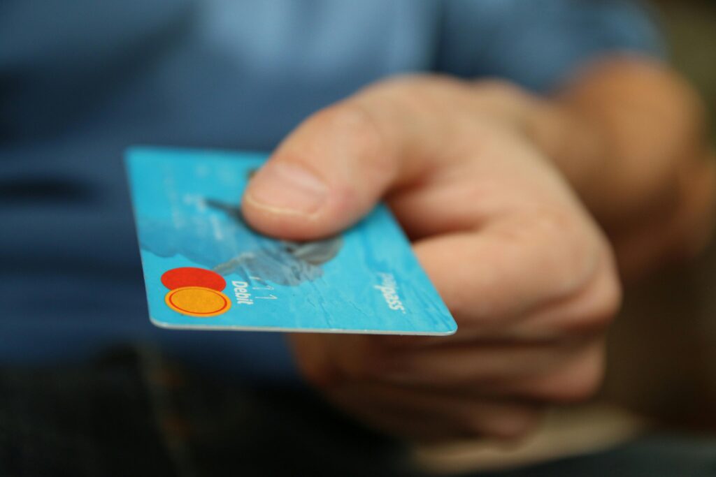 A close-up of a hand holding a credit card, ready for payment.