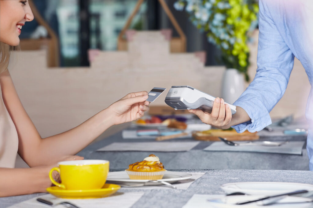 Customer using modern card machine for contactless payment in Irish business