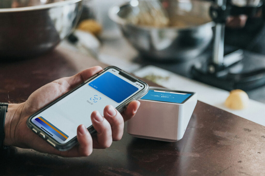 Customer using digital wallet in Ireland to make contactless payment at cafe