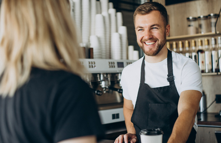 Person making contactless payment in coffee shop using payment integration comparison optimized terminal