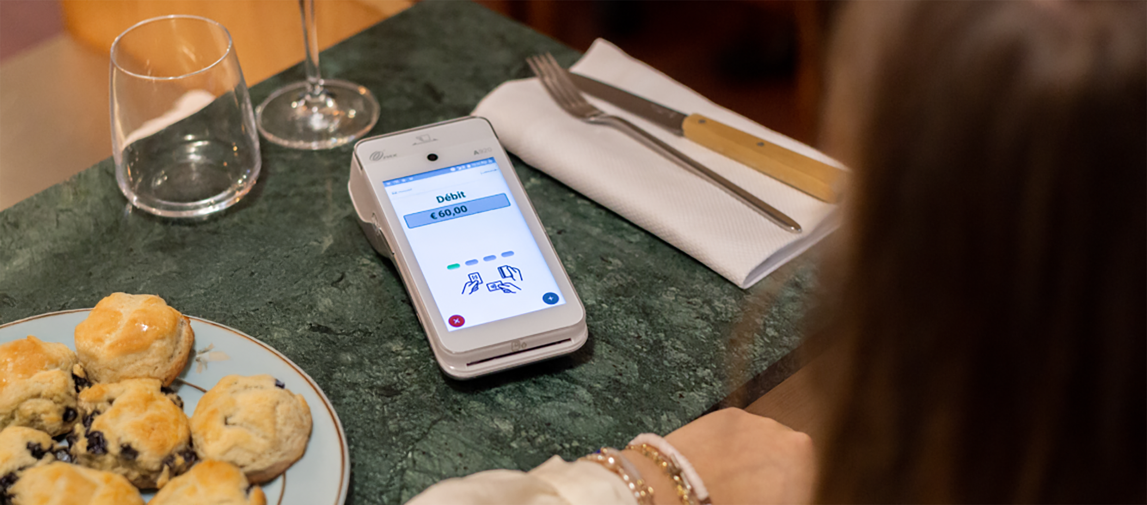 Card payment comparison calculator showing PAX A920 terminal on restaurant table revealing true costs