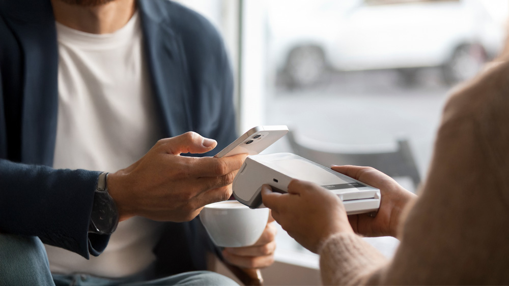 Person making fast contactless payment during payment processor comparison speed test